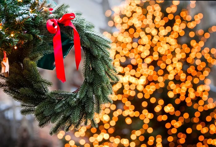 A festive decoration set against a backdrop of softly blurred lights.