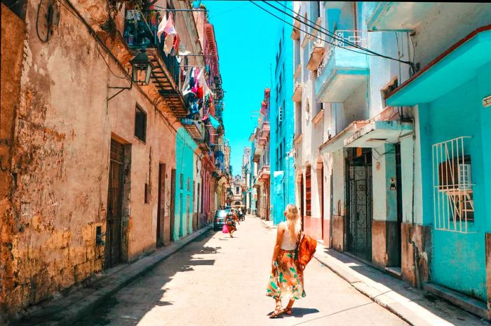 A tourist woman strolling through the streets of Old Havana, Cuba, on a sunny day