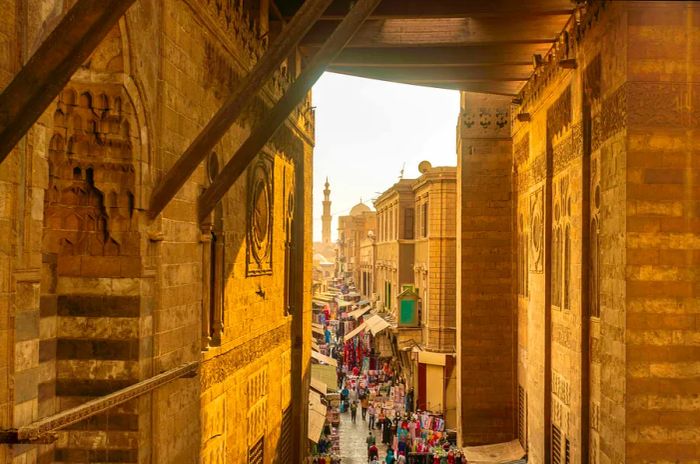 People stroll through a bustling market street in the city