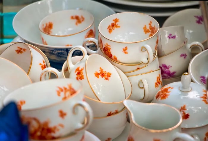 A collection of vintage tea cups adorned with vibrant floral patterns.