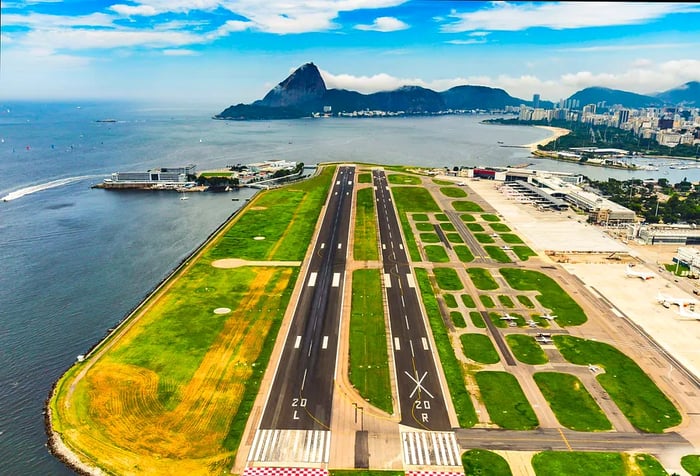 A seaside airport featuring two runways.