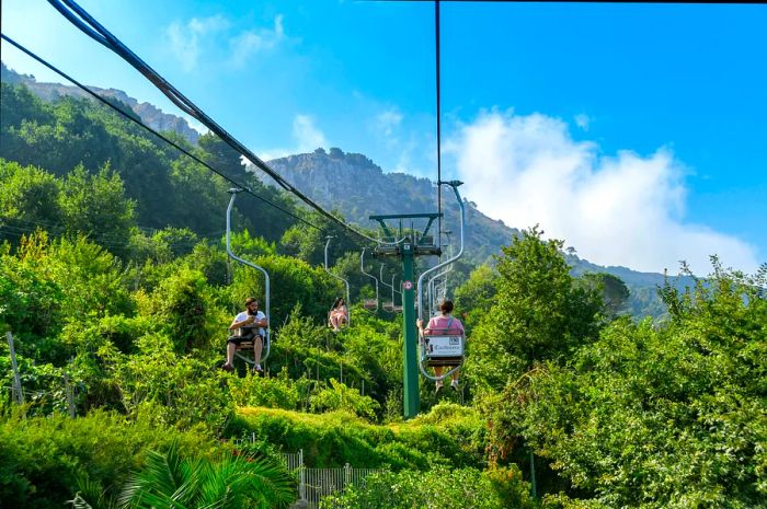 A person riding a chairlift ascending Mount Solaro on Capri