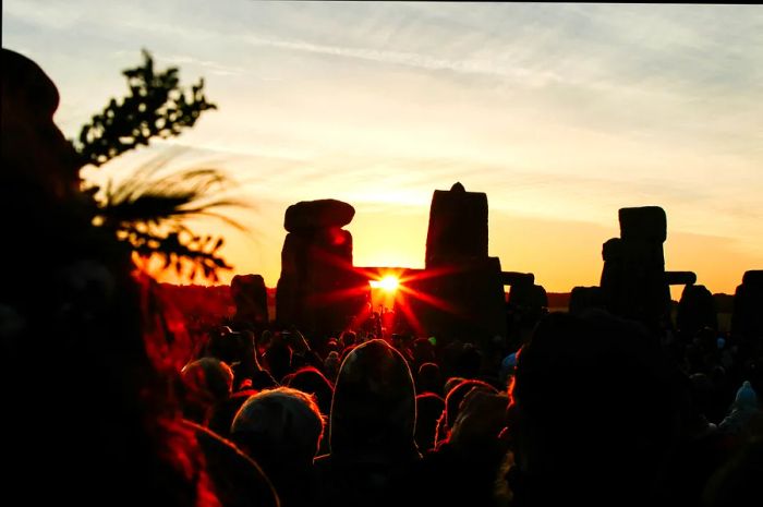 Visitors gather to witness the summer solstice at dawn at Stonehenge.