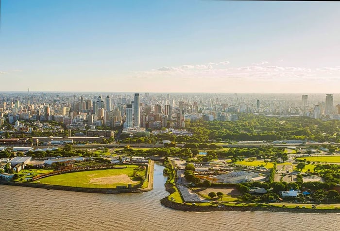 The stunning skyline of Buenos Aires unfolds beside the calm waters, where the lively spirit of the city meets the peaceful touch of the river.