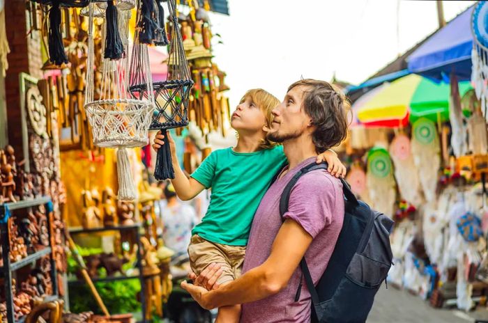 A father and son explore crafts at a local market