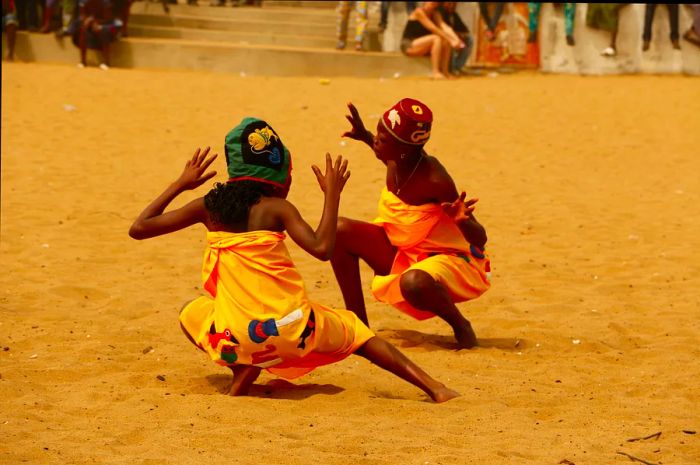 Children singing and dancing at the Vodou festival on the beach in Ouidah, Benin