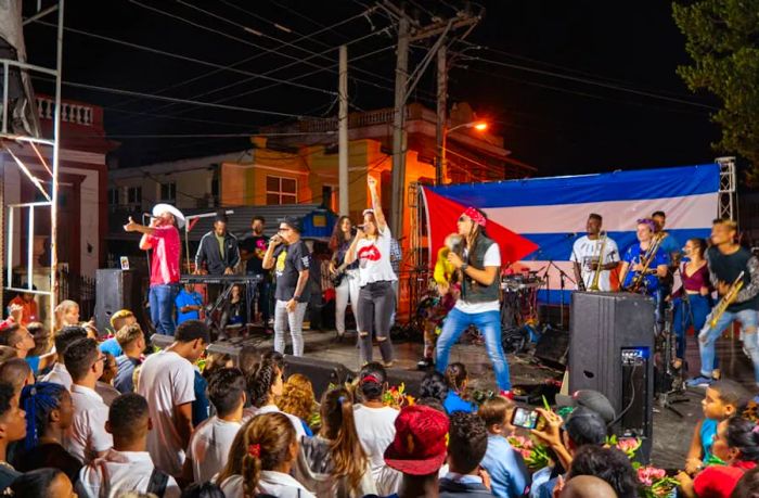 An evening performance by the Qva Libre music group during a lively street show in Santa Clara, Cuba