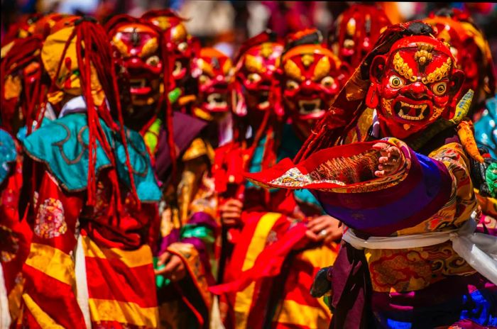 Masked dancers perform during the tsholing ceremony at Paro Dzong, Bhutan.