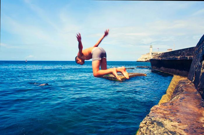 A boy leaps into the sea from the Malécon in Havana, Cuba