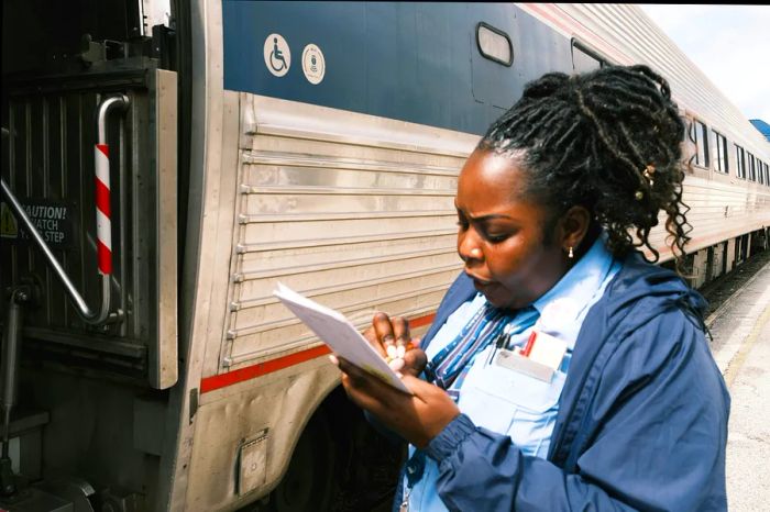 A Silver Meteor attendant checks off passenger names as they board the train.