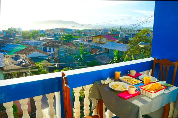 Enjoy breakfast at a table with a view of the Cuban city of Baracoa.