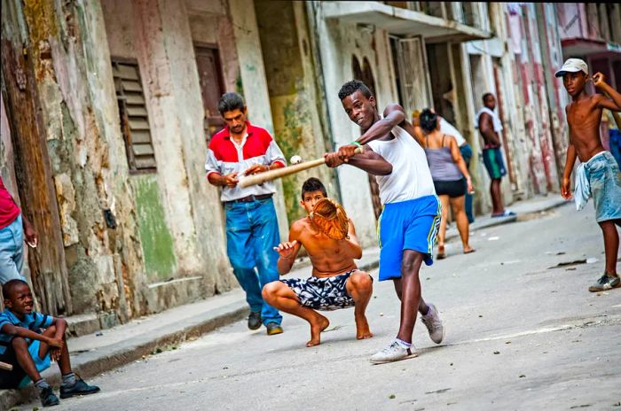 Children playing soccer on a Havana street.