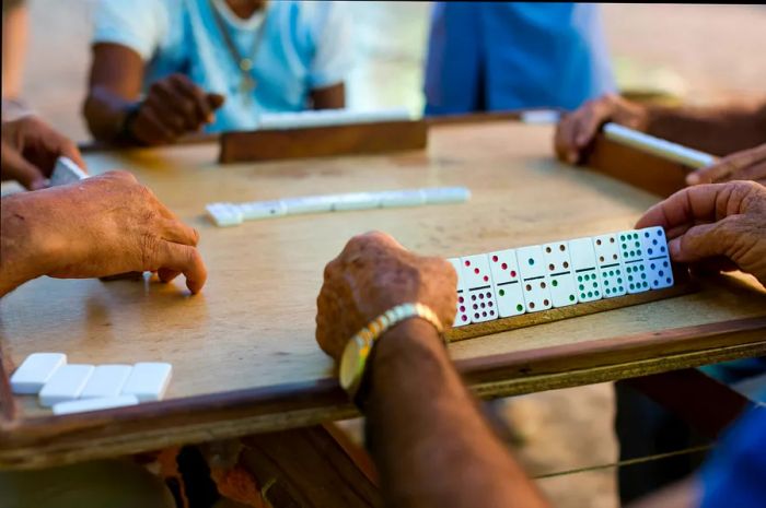 Men engaged in a game of dominoes in Cuba.