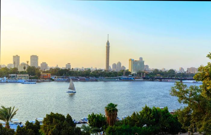 The Nile River flows through Cairo, dotted with small sailboats