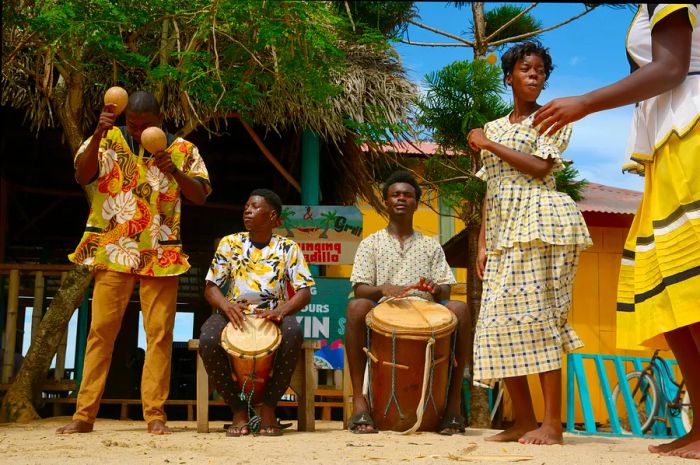 A Garifuna group showcases traditional songs accompanied by drumming and dancing in Hopkins Village.