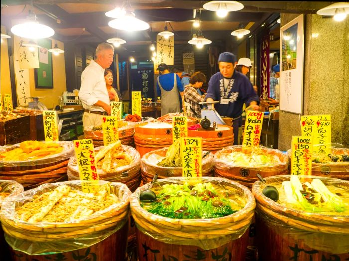 A vendor dressed in traditional attire selling food at Nishiki Market in Kyoto’s Nakagyo district.