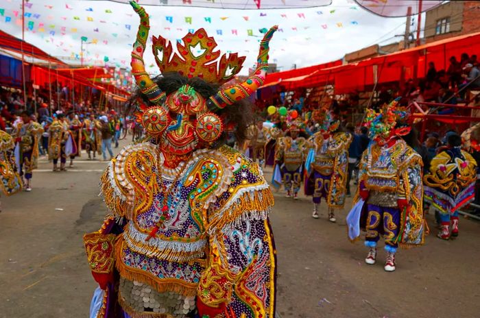 Diablada dancers in elaborate costumes get ready to parade through the mining town of Oruro on Bolivia's Altiplano during the annual carnival.