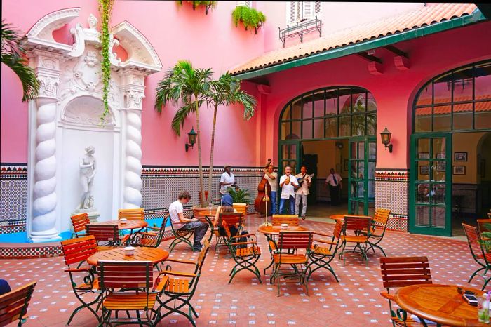 Musicians perform in the pink-tiled courtyard of the historic Hotel Sevilla in Havana.