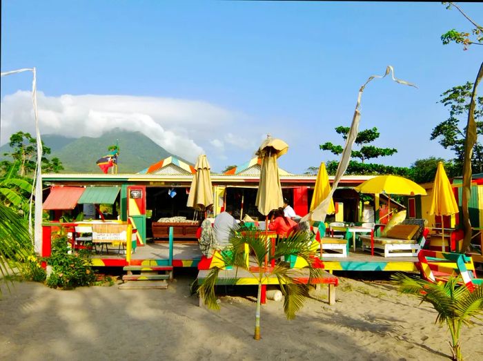 Sunshine's Beach Bar & Grill on Nevis, painted in vibrant yellow, green, and red hues