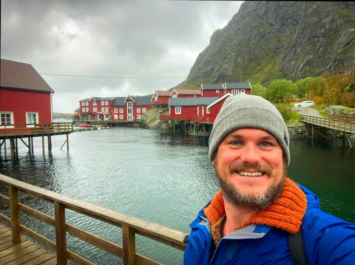 The author is depicted at the harbor of the quaint fishing village of Å.