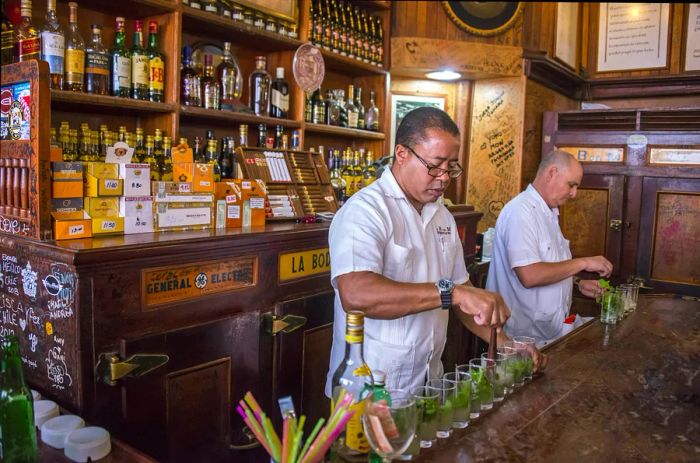 Two bartenders mixing mojitos in Havana, Cuba