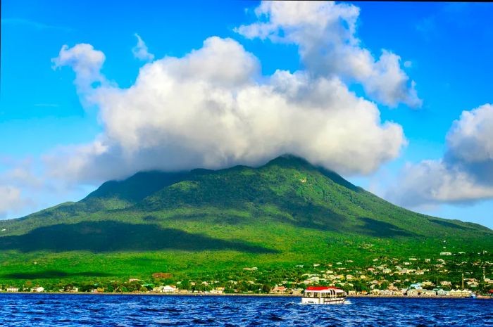 Nevis Peak shrouded in clouds, seen from the sea