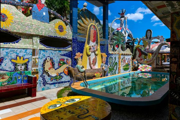 An outdoor pool area adorned with intricate and vibrant mosaic art in Jaimanitas, located on the outskirts of Havana.