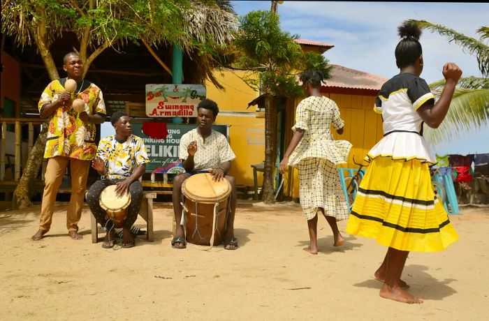 A Garifuna group showcases traditional songs through drumming and dancing in the village of Hopkins.