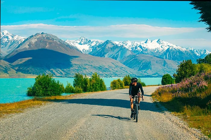 A cyclist riding along the shores of Lake Pukaki, South Island, New Zealand