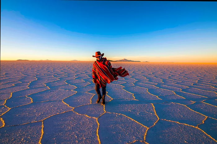 Man wearing a poncho at Salar de Uyuni, Altiplano, Bolivia