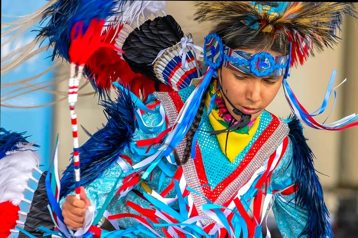 A young Indigenous boy dressed in vibrant traditional attire, Alberta, Canada