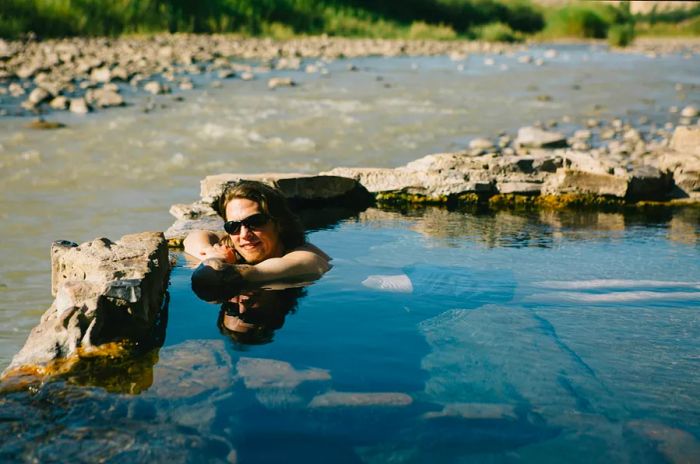 A woman enjoys a soak in a hot spring at Big Bend National Park, Texas