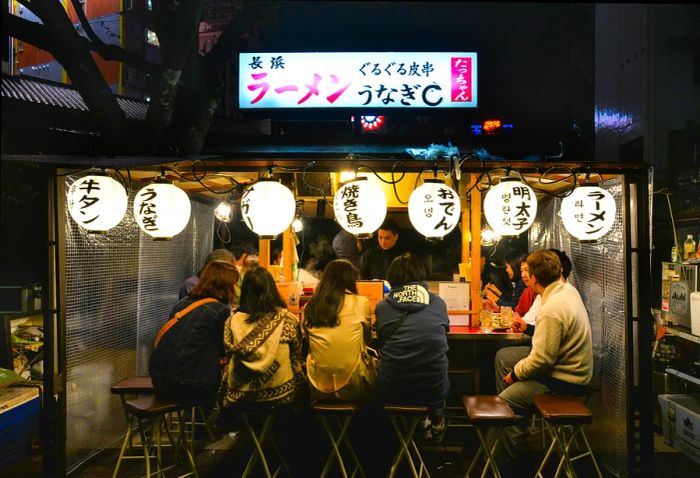 Diners enjoying meals at a yatai in Canal City, Fukuoka, Japan