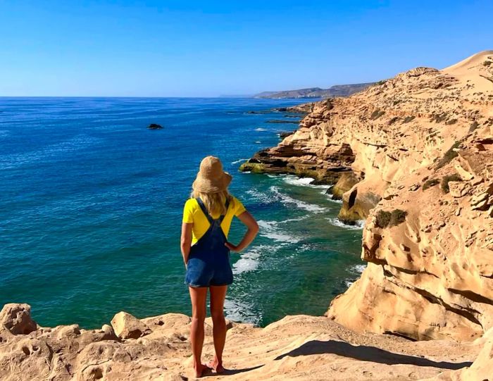 Sally Kirby gazes out over the rugged Atlantic coastline in Tamri, Morocco.