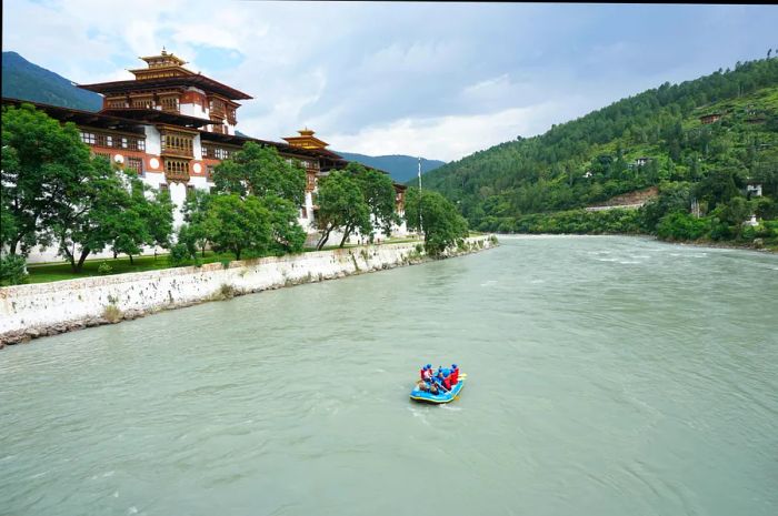 A group rafting in front of the majestic Punakha Dzong, Punakha, Bhutan