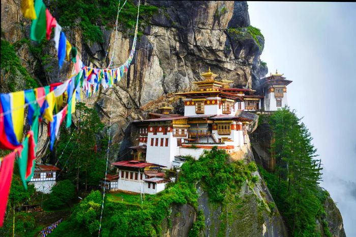 Taktsang Monastery (Tiger’s Nest), perched near Paro, Bhutan, is a stunning white structure clinging to a sheer rock cliff.