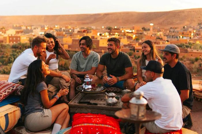 A group of friends enjoying tea and sharing laughs at a Moroccan teahouse.