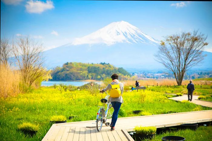 Bikers and hikers in front of Mt. Fuji at Kawaguchiko Lake