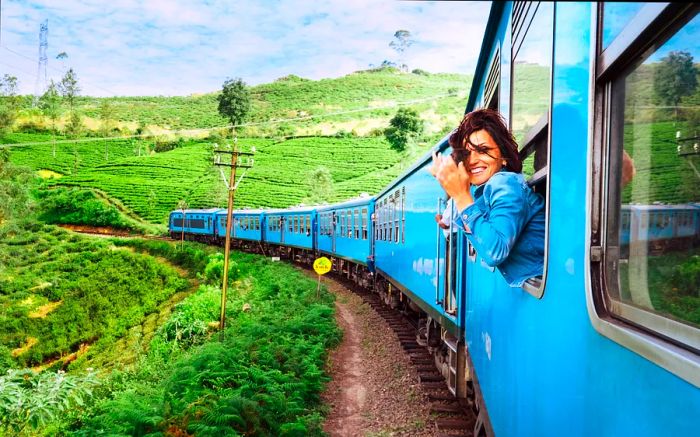 A cheerful woman gazes out of a train window as it glides through Sri Lanka's scenic landscape.