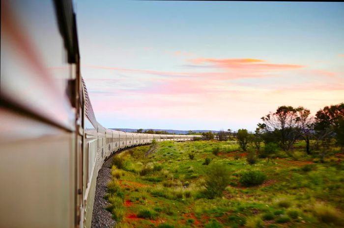 A train meanders through the rugged outback of Australia.