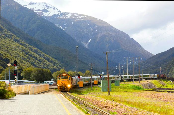 A Kiwirail TranzAlpine train arrives at Arthur’s Pass station in Arthur’s Pass National Park, South Island, New Zealand.