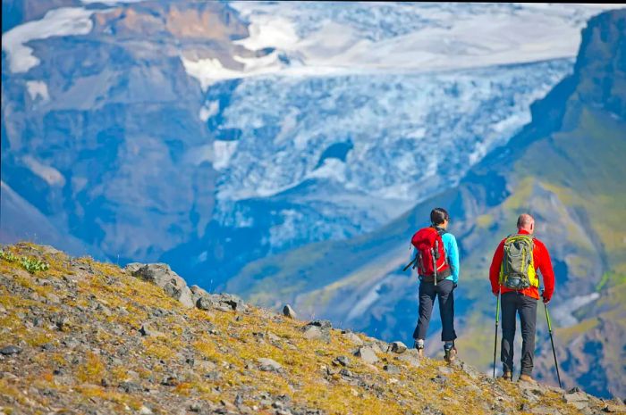 A couple hiking towards Fimmvörðuháls Pass above Þórsmörk Valley in South Iceland.