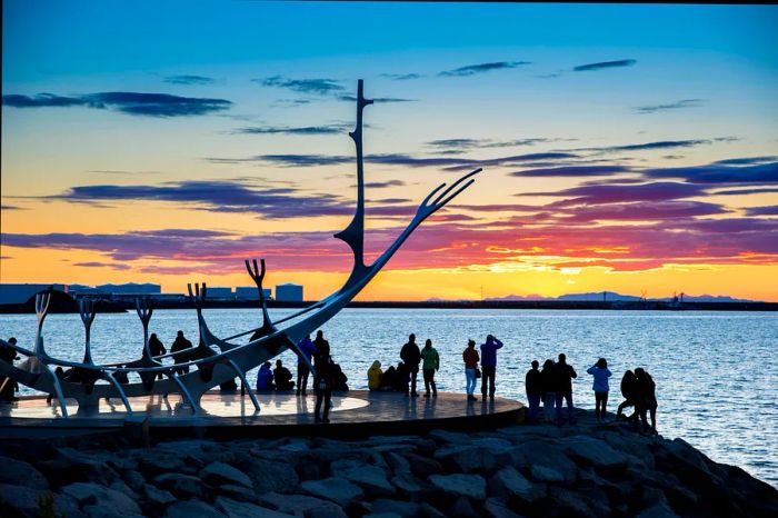 People congregate around the Sun Voyager sculpture in Reykjavik.