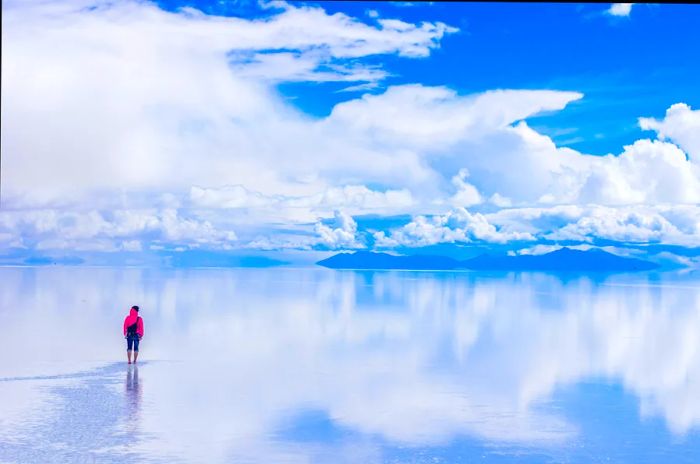 A traveler on the shimmering salt flats of Salar de Uyuni