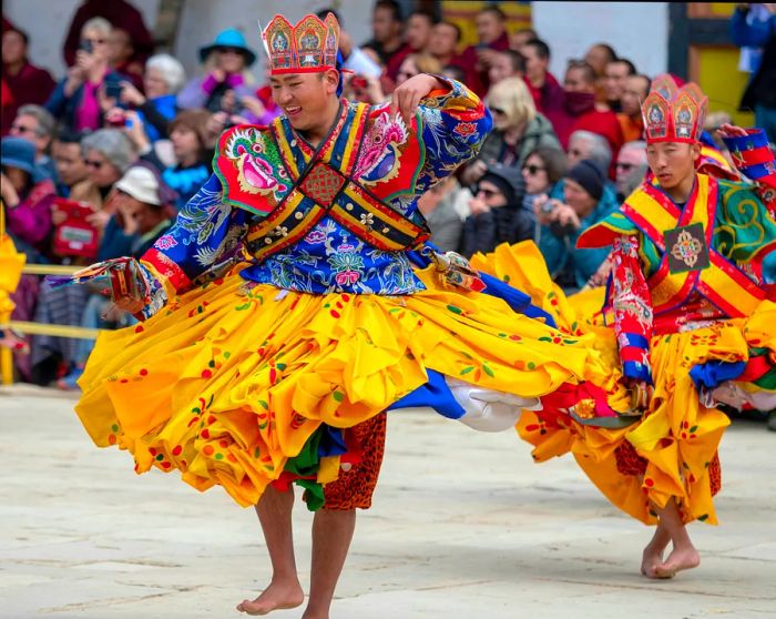 Performers at Gangtey Monastery in the Phobjikha Valley, Bhutan, showcase their talents during the Black-Necked Crane Festival, an annual event celebrating the return of these birds from their breeding grounds in Tibet each winter.