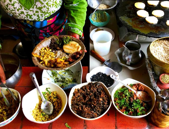 A woman in Kathmandu serves Newari cuisine, a culinary tradition that has evolved over centuries among the Newars of the city.