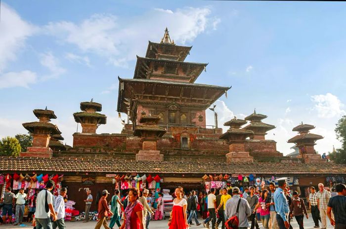 Throngs of visitors gather at the ancient walls of the Taleju Bhawani Temple in Kathmandu's Durbar Square.