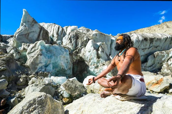 A sadhu (holy man) meditating on a rock at Gaumukh, the source of the sacred River Ganges