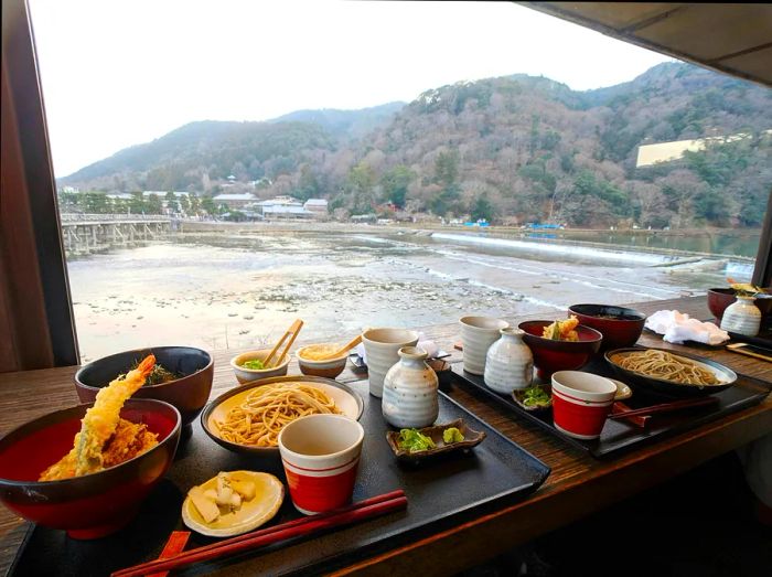 Enjoying a soba and tempura set lunch at Yoshimura restaurant, with a scenic river view of Arashiyama, Kyoto, Japan