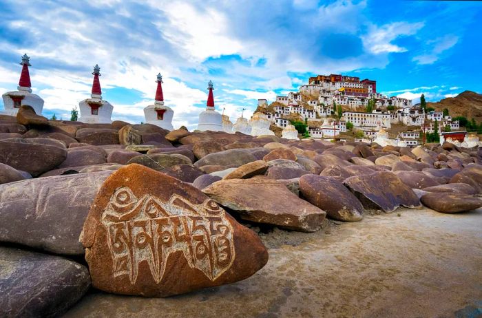 Scenic view of Thikse Monastery alongside prayer rocks in Ladakh, India